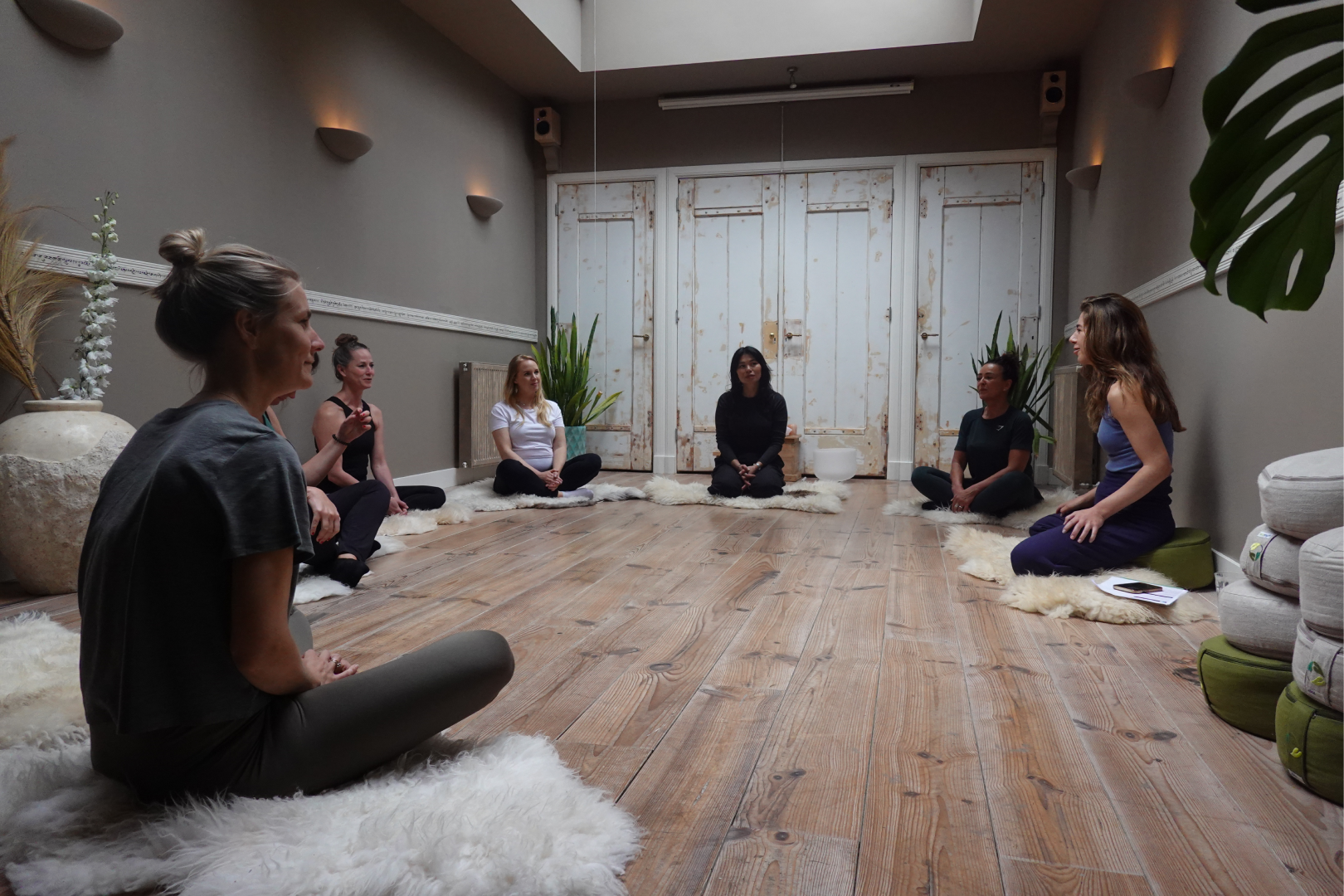 The SØSOUL sanctuary in the Jordaan, a circle seated before the weathered white doors